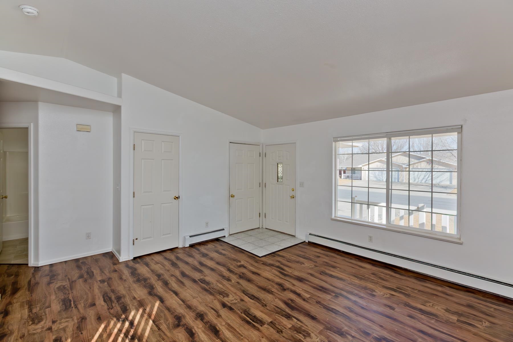 513 April Lane, Unit A Grand Junction, CO 81504 - Photo 11 of 31 a view of an empty room with wooden floor and window