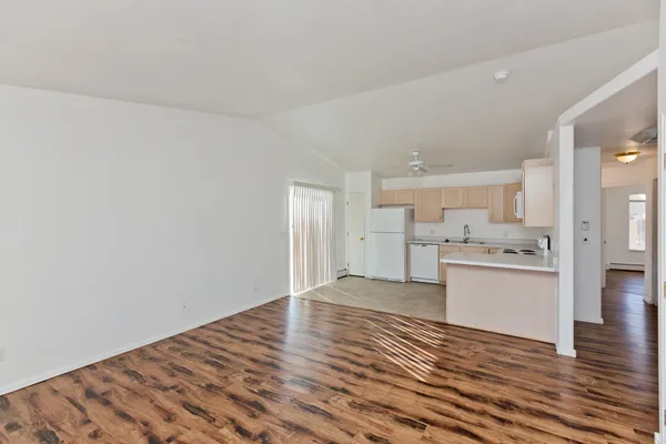 a view of a kitchen with wooden floor and a sink