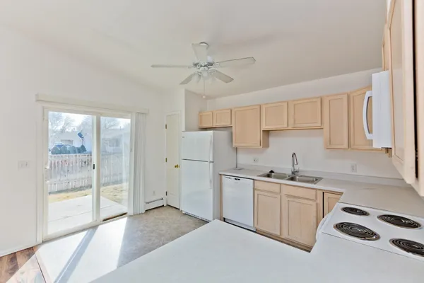 a kitchen with a sink cabinets and wooden floor