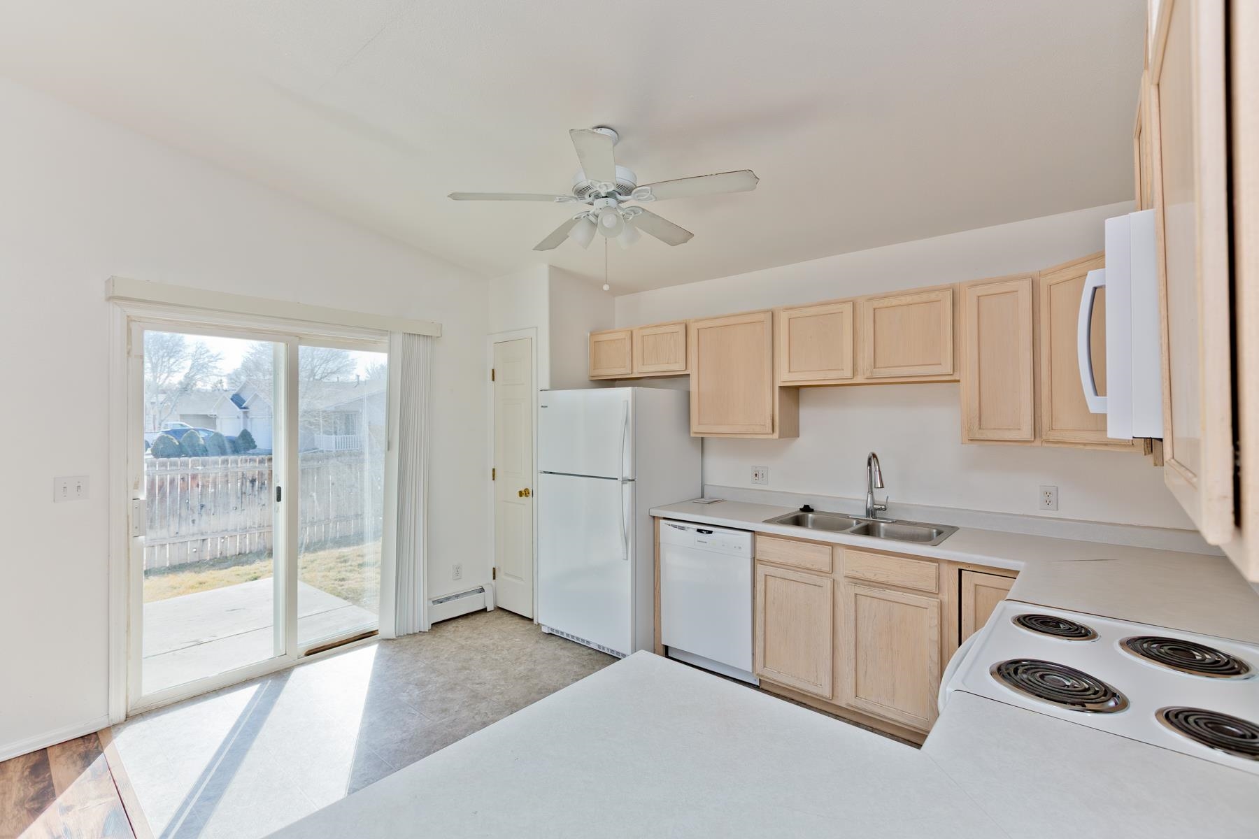 513 April Lane, Unit A Grand Junction, CO 81504 - Photo 15 of 31 a kitchen with a sink a stove cabinets and a refrigerator