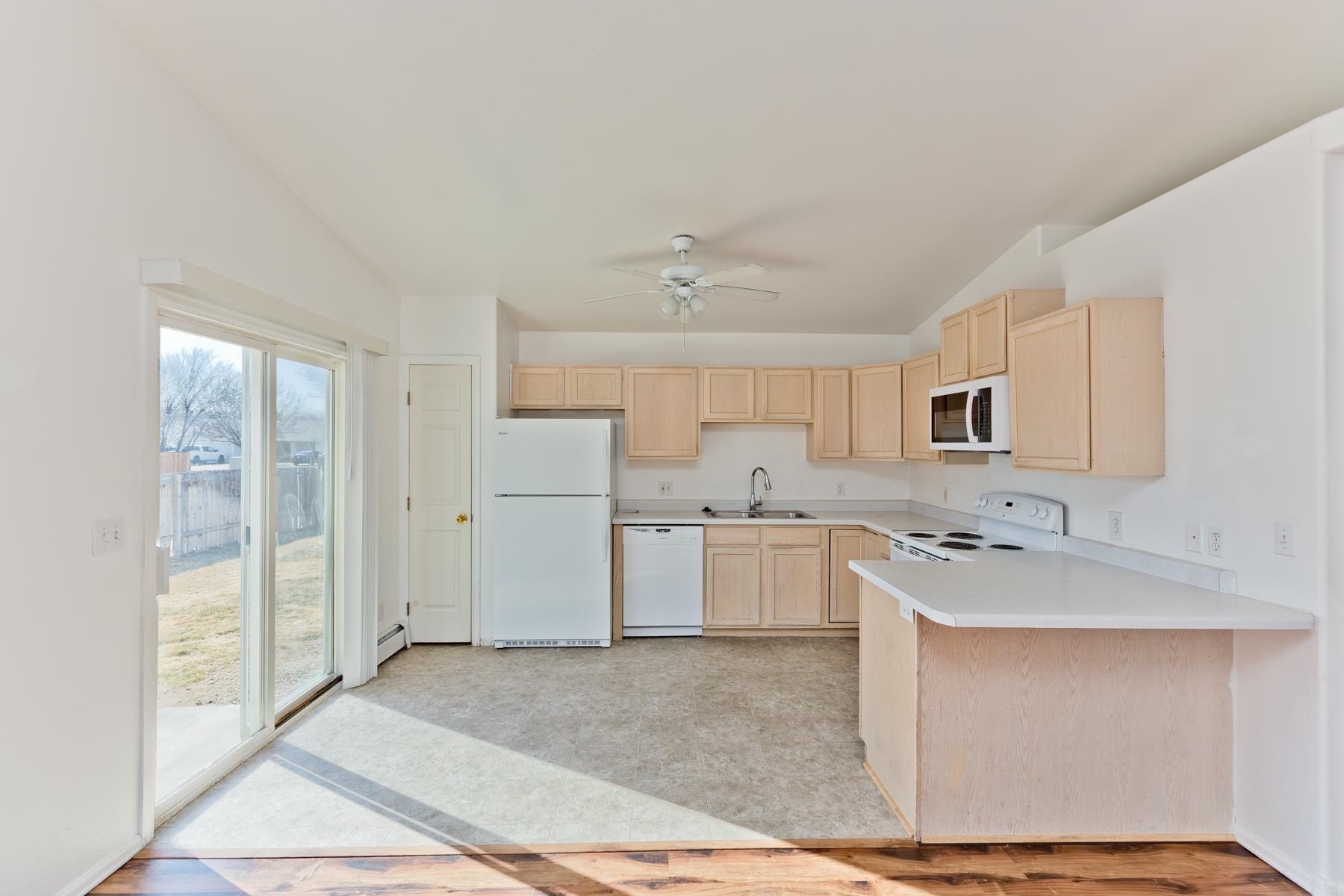 513 April Lane, Unit A Grand Junction, CO 81504 - Photo 16 of 31 a kitchen with a sink cabinets and wooden floor