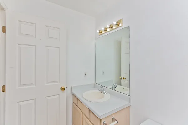 a view of a small space with wooden floor and a window
