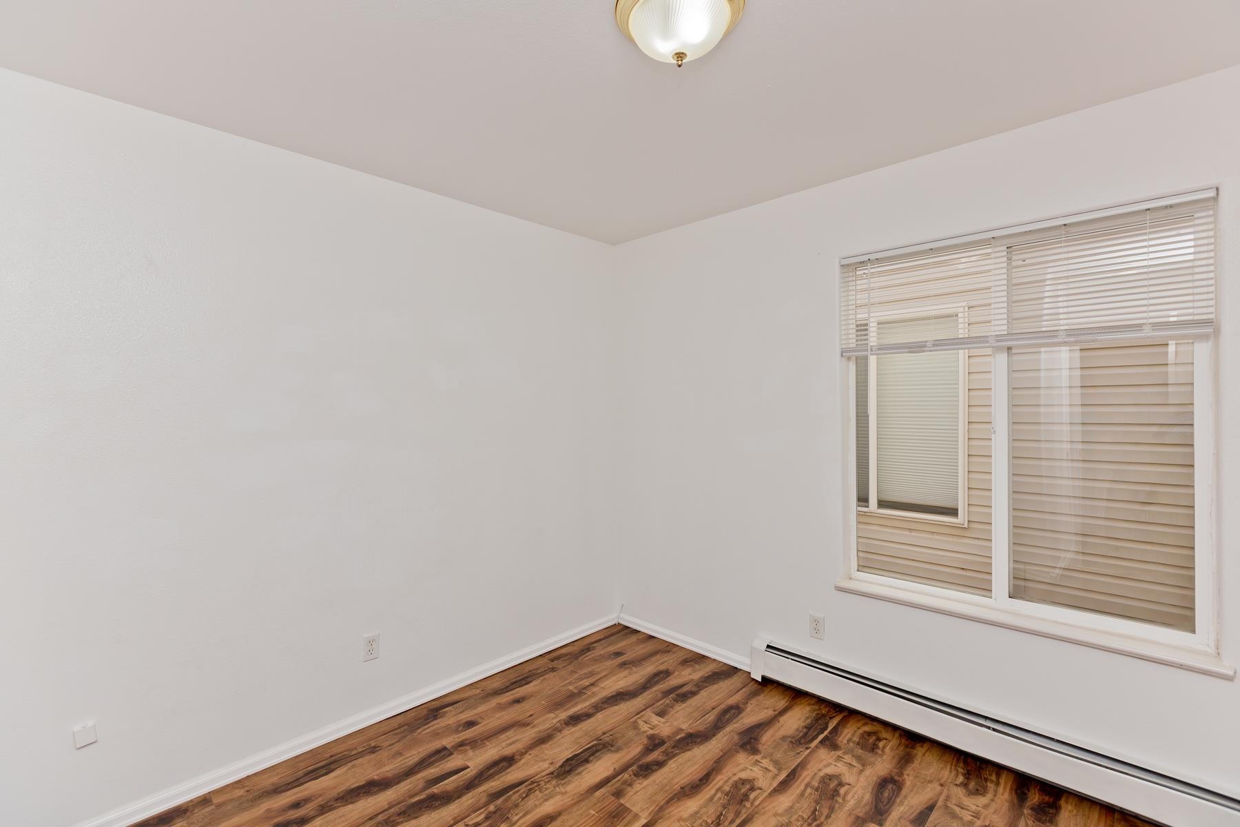 513 April Lane, Unit A Grand Junction, CO 81504 - Photo 23 of 31 a view of a small space with wooden floor and a window