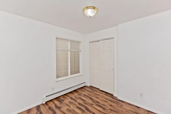 a view of a room with wooden floor