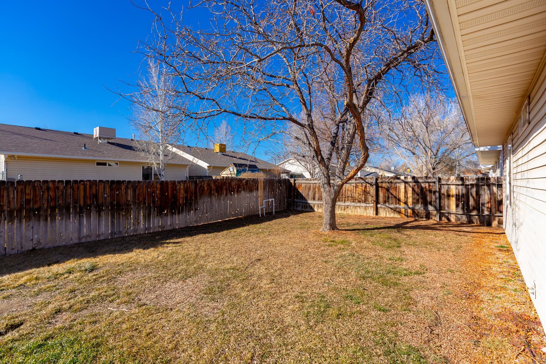513 April Lane, Unit A Grand Junction, CO 81504 - Photo 9 of 31 a view of a yard with wooden fence