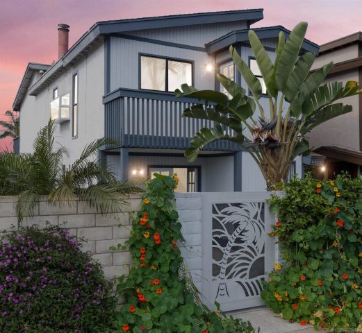 a view of a house with brick walls and flower plants