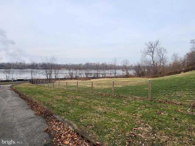 a view of a lake with houses in the back