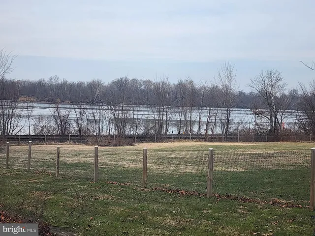 a view of a lake with houses in the back