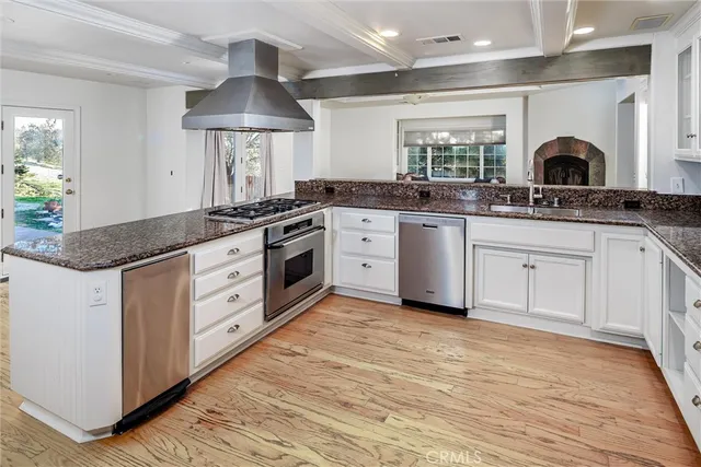a kitchen with stainless steel appliances granite countertop a sink and cabinets