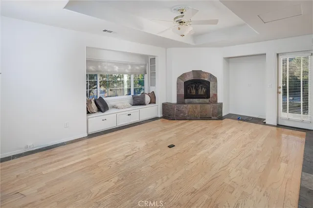 a living room with a fireplace and a large window