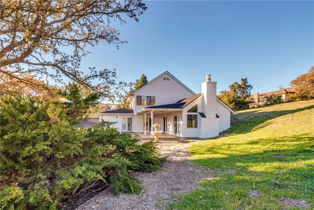 a front view of a house with a garden and yard