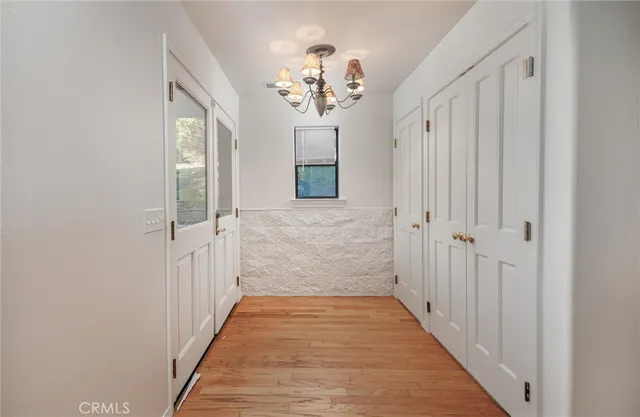 a view of a hallway view with wooden floor and staircase
