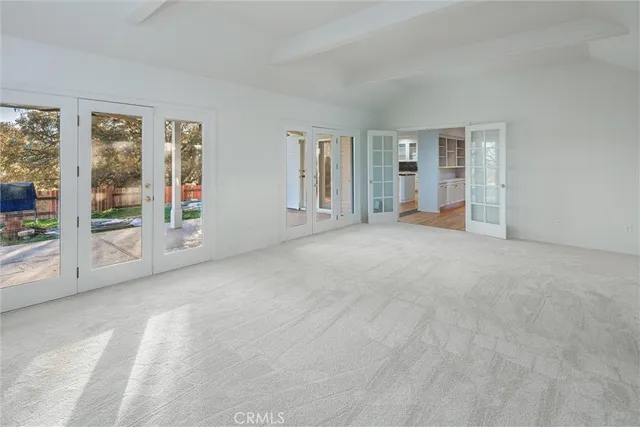 a view of an empty room with glass door