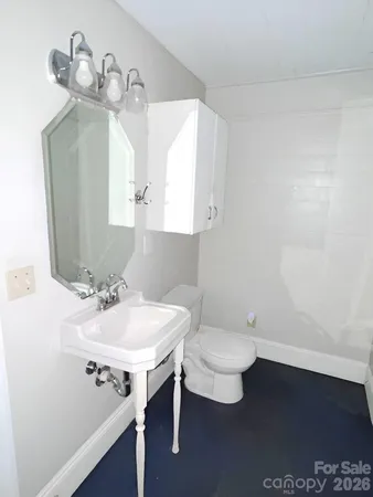 a bathroom with a sink a toilet and mirror