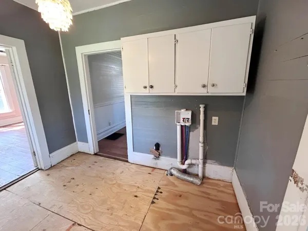 a view of a room with wooden floor and cabinet