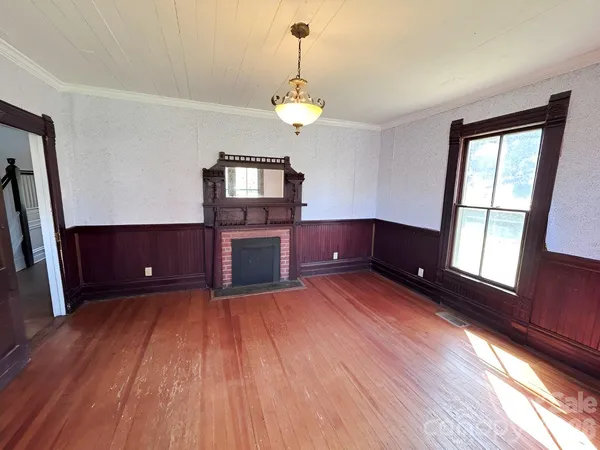 a view of kitchen and hall with wooden floor