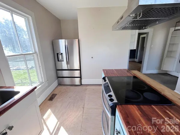a kitchen with stainless steel appliances granite countertop a stove and a refrigerator