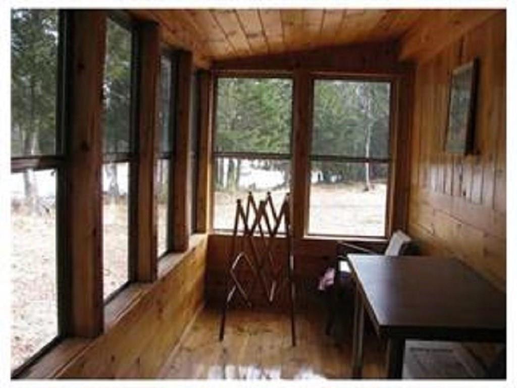 222 Mattamiscontis Road Howland, ME 04448 - Photo 8 of 15 Glassed porch area on the side of...
