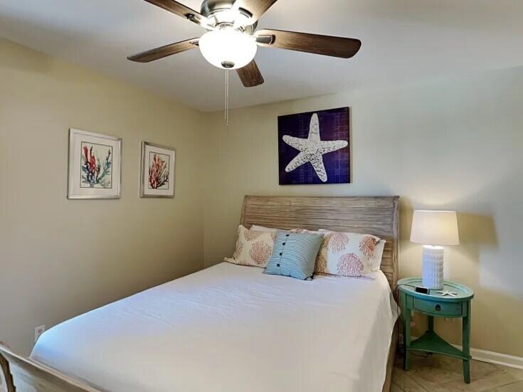 4984 West County Highway 30A Road, Unit 7B Santa Rosa Beach, FL 32459 - Photo 24 of 40 a bedroom with a bed and a chandelier