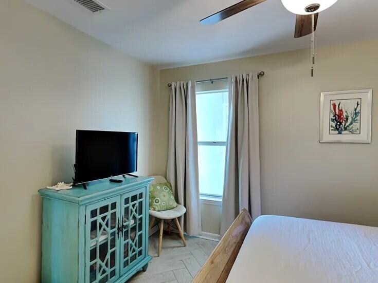 4984 West County Highway 30A Road, Unit 7B Santa Rosa Beach, FL 32459 - Photo 25 of 40 a bedroom with furniture and flat screen tv