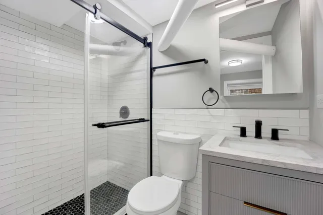 a bathroom with a toilet sink and shower