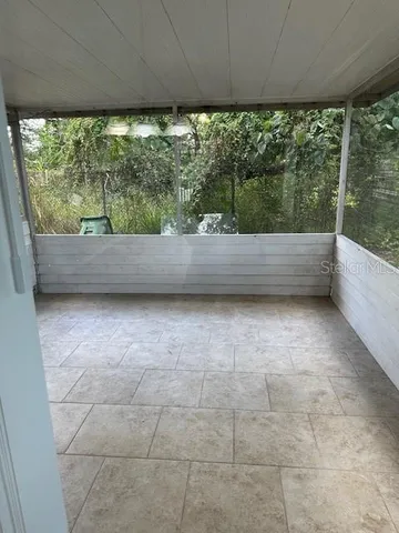 a view of room with a floor to ceiling window and a yard