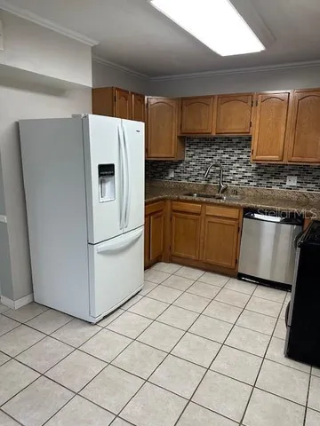 a kitchen with stainless steel appliances granite countertop a refrigerator sink and microwave