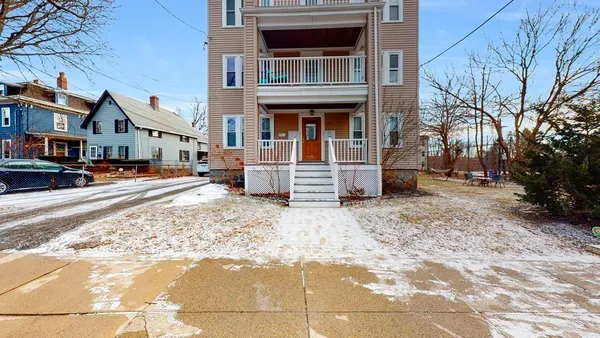 a front view of a residential apartment building with a yard