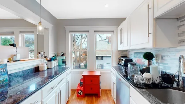 a kitchen filled with stainless steel appliances granite countertop a sink and a counter space