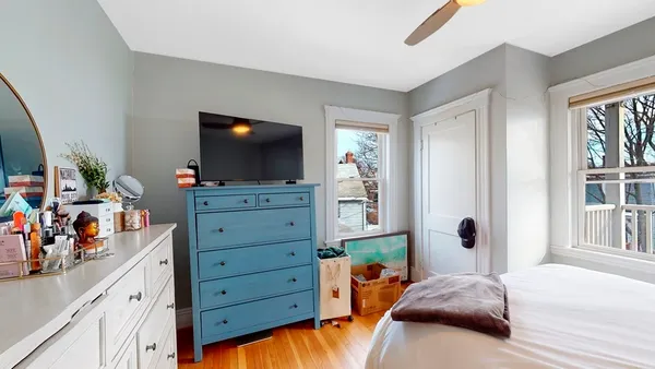 a bedroom with a bed and flat screen tv