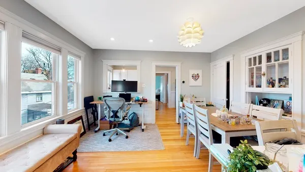 a view of a livingroom with workspace and a window
