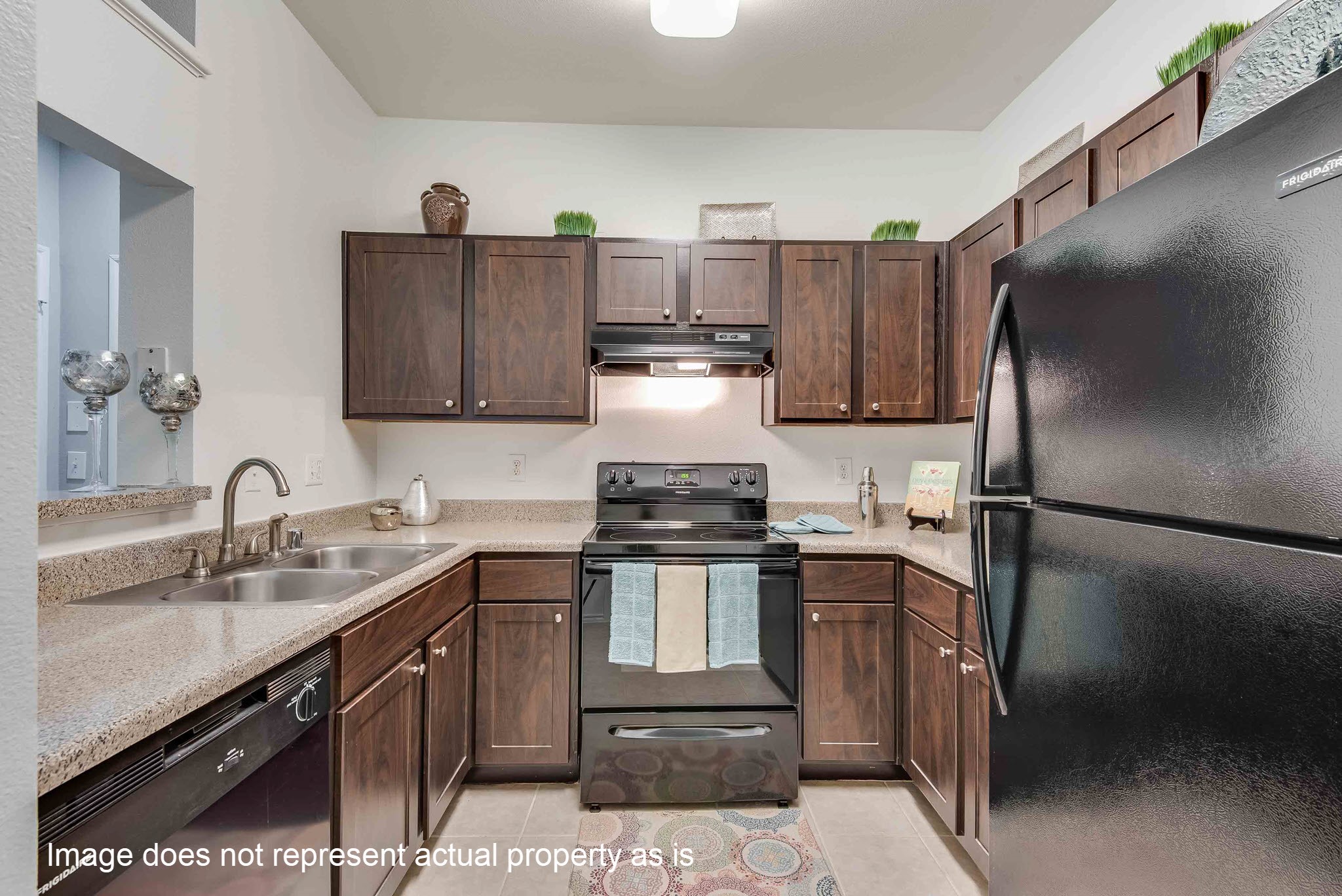 2400-413 Spring Rain Drive Spring, TX 77379 - Photo 5 of 37 a kitchen with stainless steel appliances granite countertop a sink stove and refrigerator