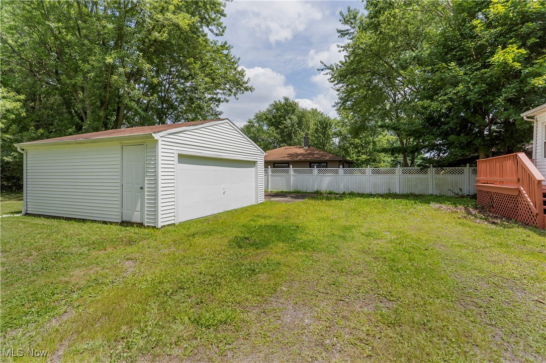 1424 Carson Salt Road Warren, OH 44481 - Photo 6 of 37 View of yard with an outdoor structure, a detached garage, and view of wooded area