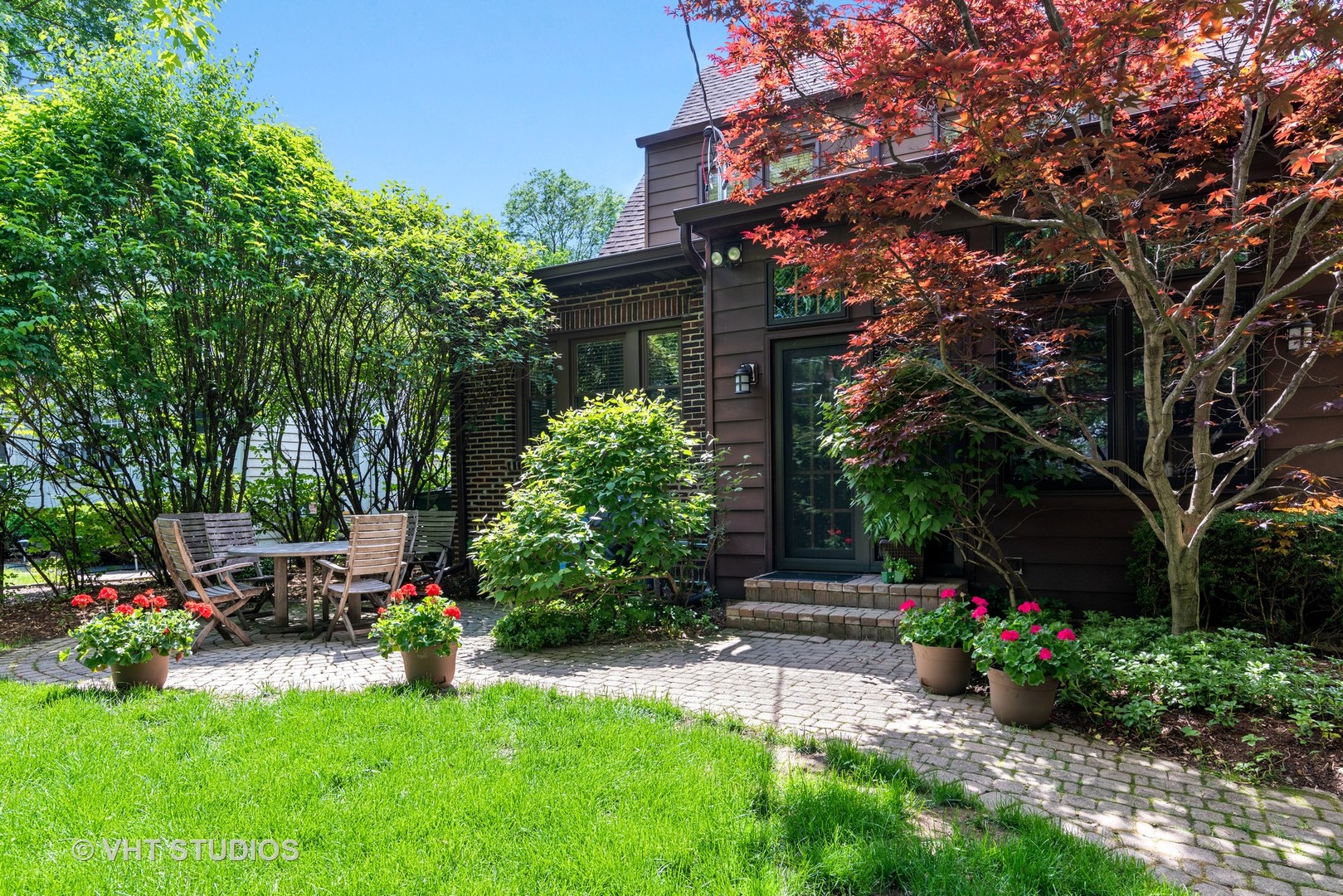 211 North Merrill Street Park Ridge, IL 60068 - Photo 21 of 26 a view of a backyard with potted plants and a large tree