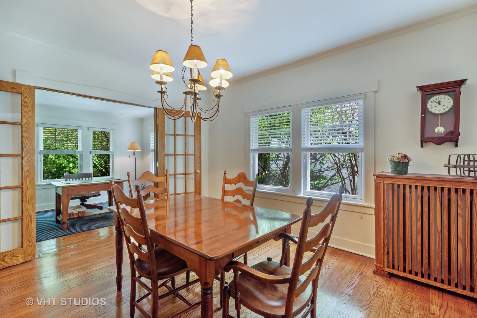 211 North Merrill Street Park Ridge, IL 60068 - Photo 10 of 26 a dining room with wooden floor a chandelier a wooden table and chairs