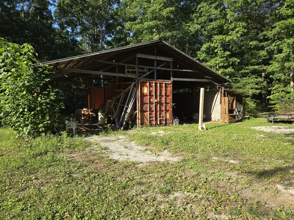 a view of a wooden house with a yard