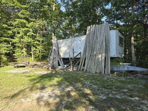 a view of a backyard with a tree and a slide