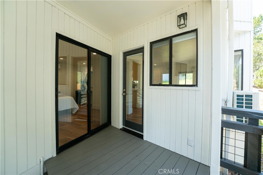 675 Huntington Road Cambria, CA 93428 - Photo 23 of 30 an empty room with wooden floor and windows