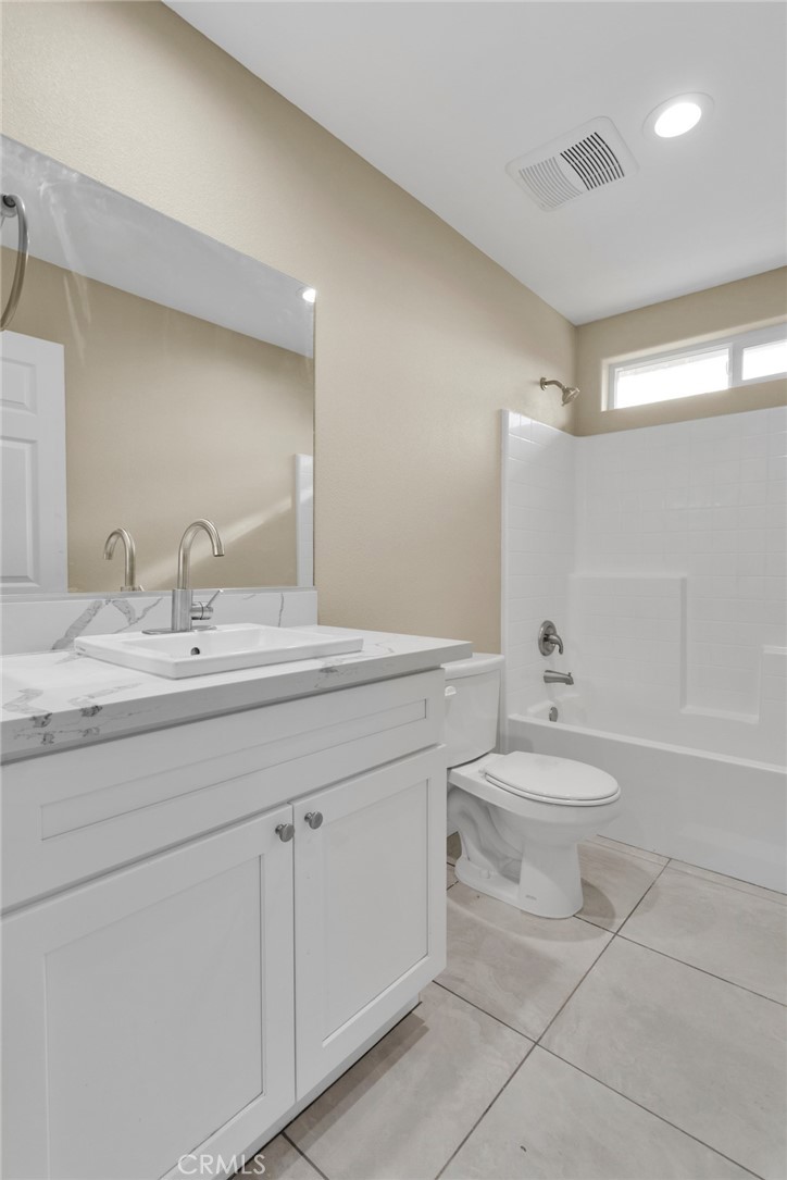 19375 Corwin Road Apple Valley, CA 92307 - Photo 11 of 27 a bathroom with a toilet a sink and bathtub