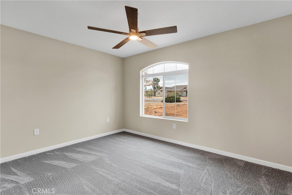 19375 Corwin Road Apple Valley, CA 92307 - Photo 12 of 27 an empty room with a window and a ceiling fan