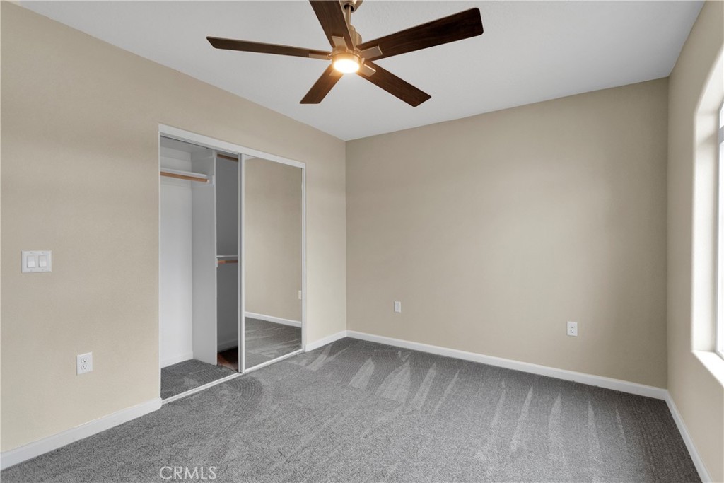 19375 Corwin Road Apple Valley, CA 92307 - Photo 13 of 27 an empty room with ceiling fan and window