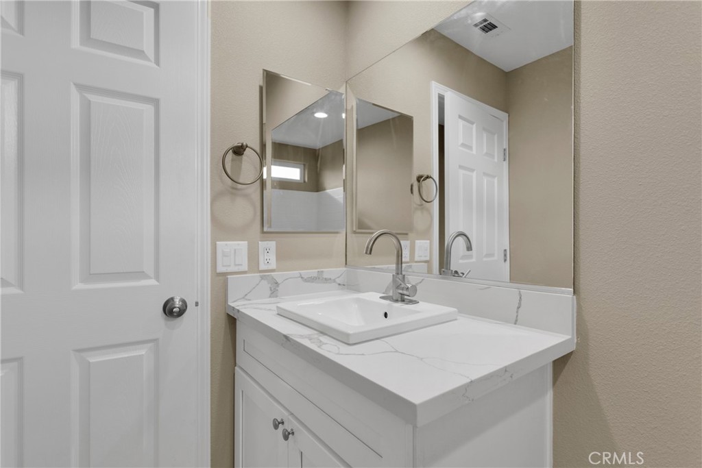 19375 Corwin Road Apple Valley, CA 92307 - Photo 15 of 27 a bathroom with a sink and a mirror