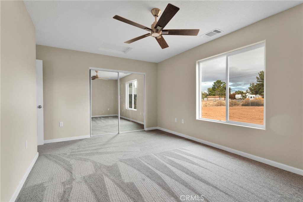 19375 Corwin Road Apple Valley, CA 92307 - Photo 17 of 27 a view of an empty room and window and a ceiling fan