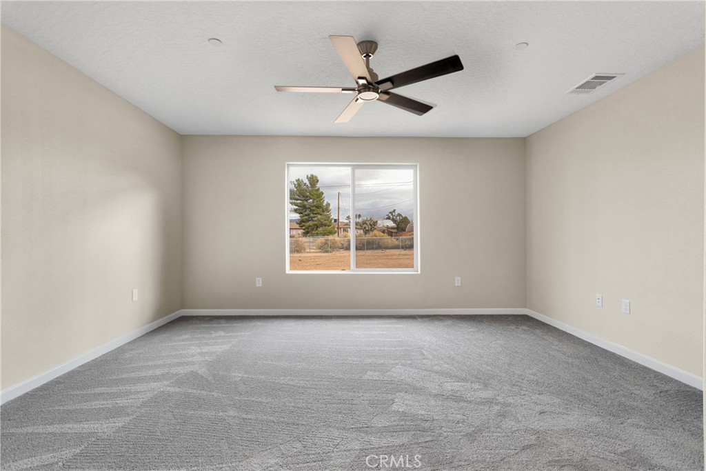 19375 Corwin Road Apple Valley, CA 92307 - Photo 21 of 27 an empty room with windows and fan