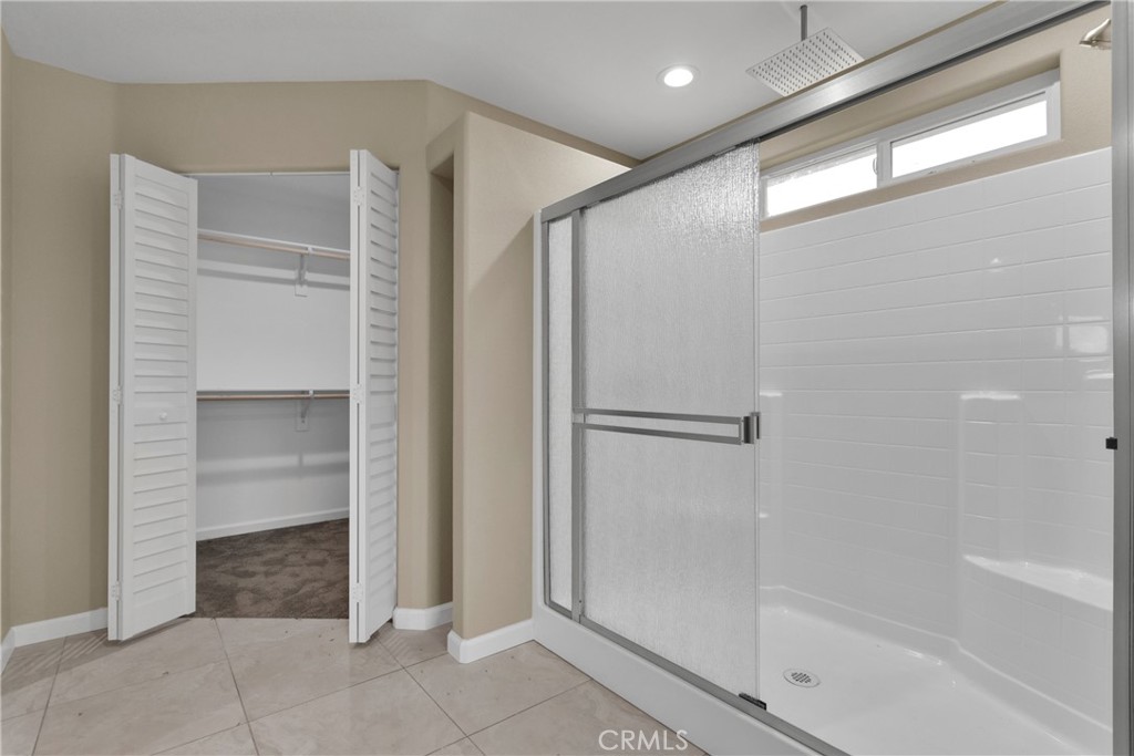 19375 Corwin Road Apple Valley, CA 92307 - Photo 24 of 27 a bathroom with a shower and a glass door