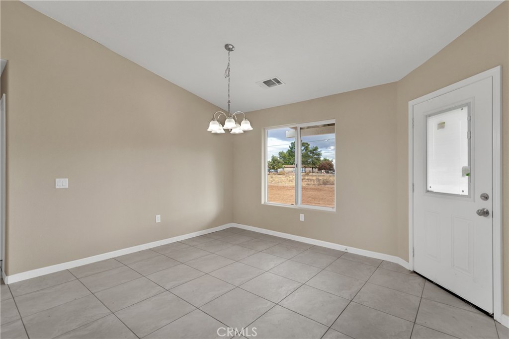 19375 Corwin Road Apple Valley, CA 92307 - Photo 5 of 27 a view of an empty room with a window