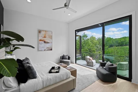 a living room with furniture and a floor to ceiling window