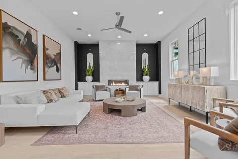 a living room with furniture and a painting on the wall