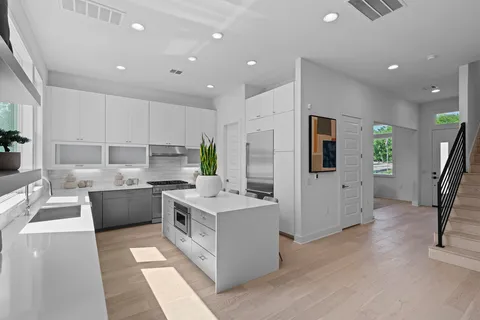 a kitchen with a sink appliances and cabinets