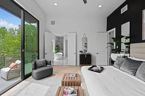 a bedroom with furniture and a large window